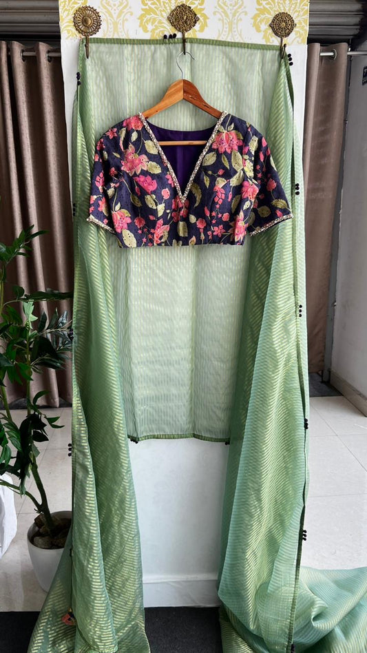 Green stripped tissue saree with purple floral hand work blouse