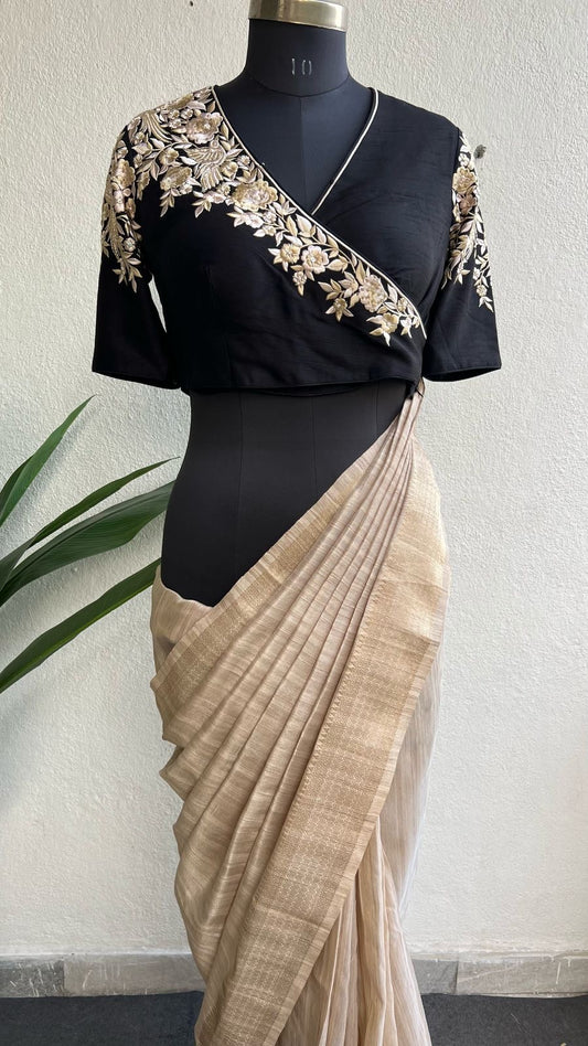 Golden cream tissue saree with black hand work blouse