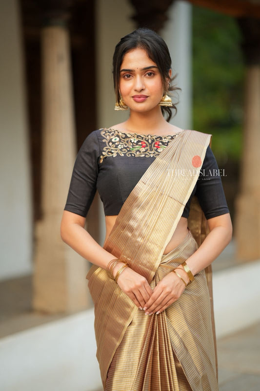 Golden tissue saree with black hand work blouse