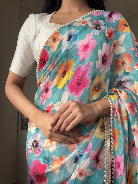 Blue floral chinnon saree with pearl hand work blouse