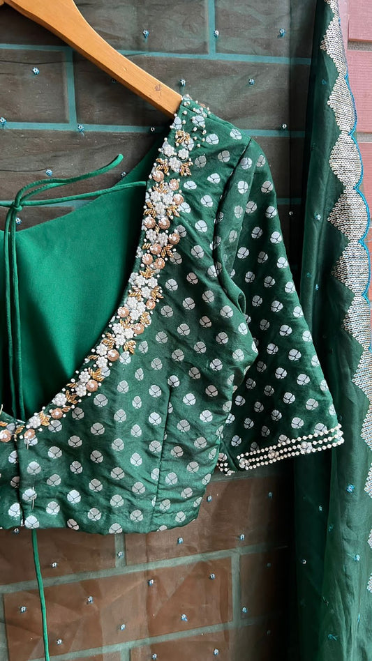 Bottle green organza saree with banarasi handwork blouse