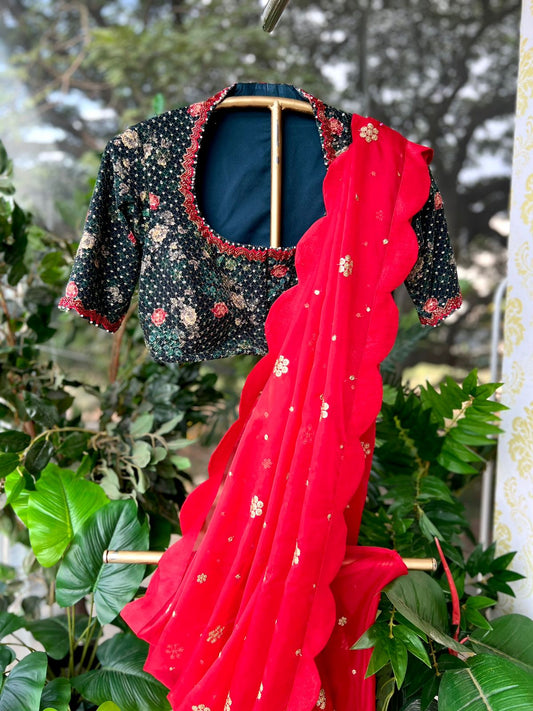 Red organza saree with greenish black handwork blouse