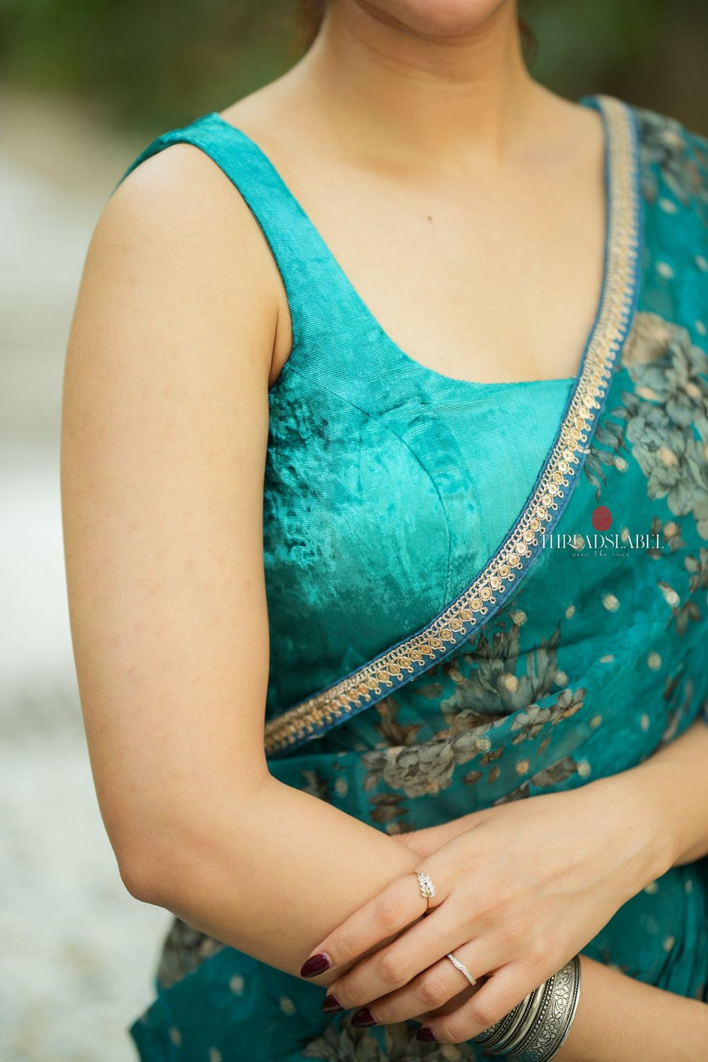 Peacock blue organza saree with velvet blouse