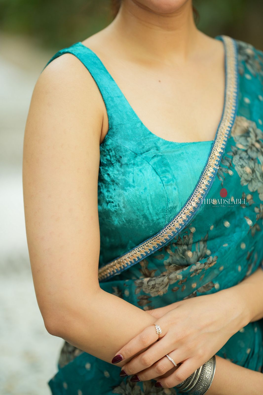 Peacock blue organza saree with velvet blouse