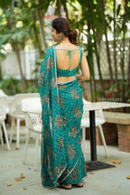 Peacock blue organza saree with velvet blouse