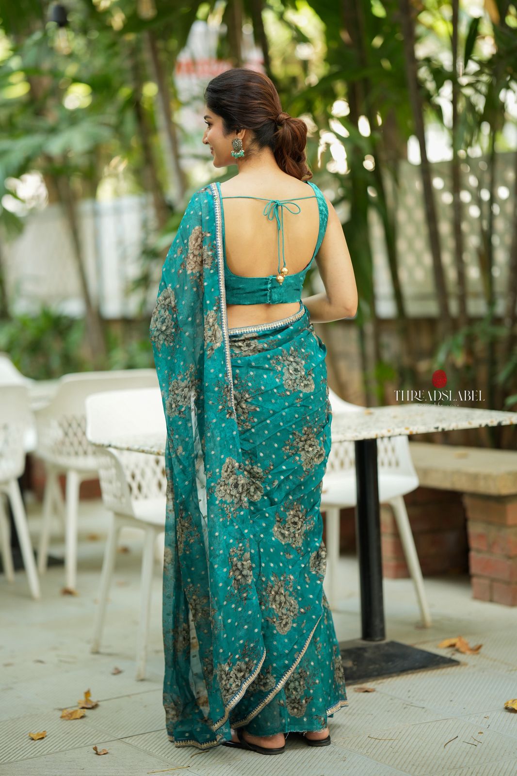 Peacock blue organza saree with velvet blouse