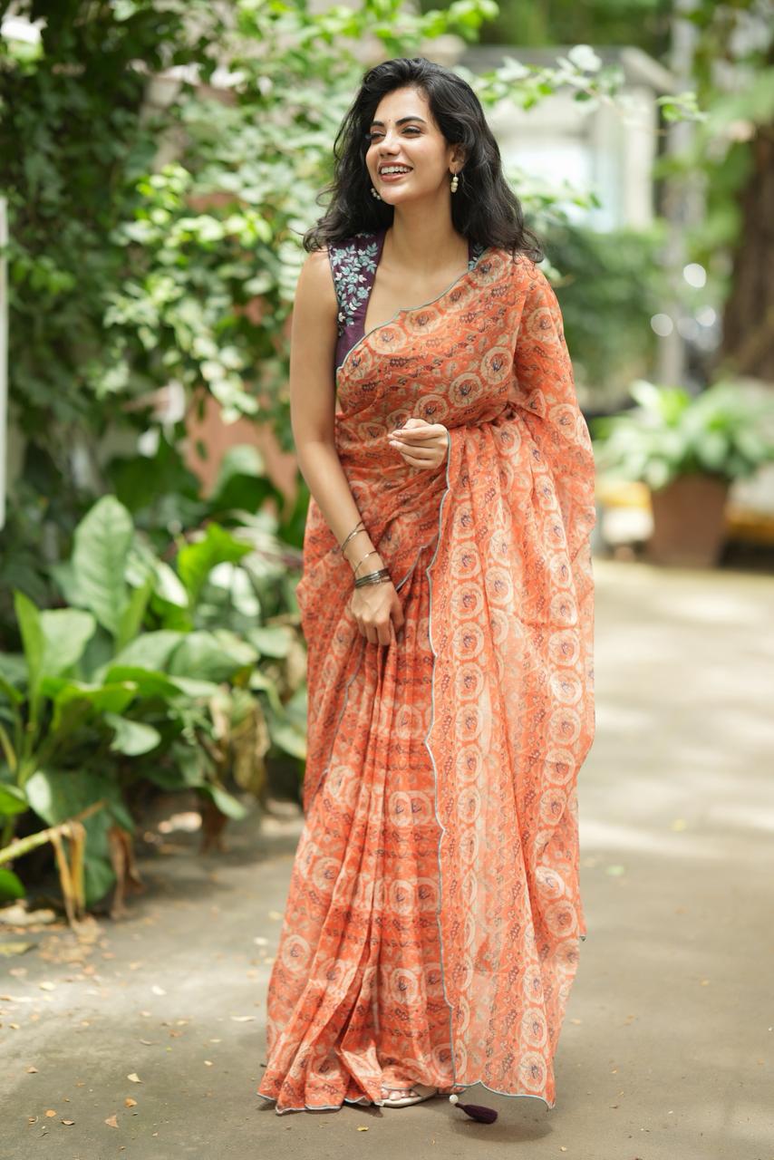 Pastel peach chiffon saree with brown hand work blouse