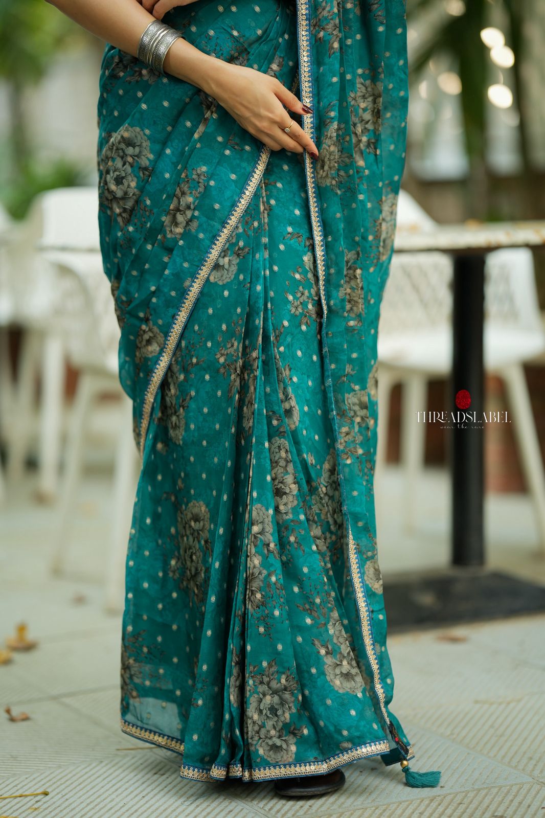 Peacock blue organza saree with velvet blouse