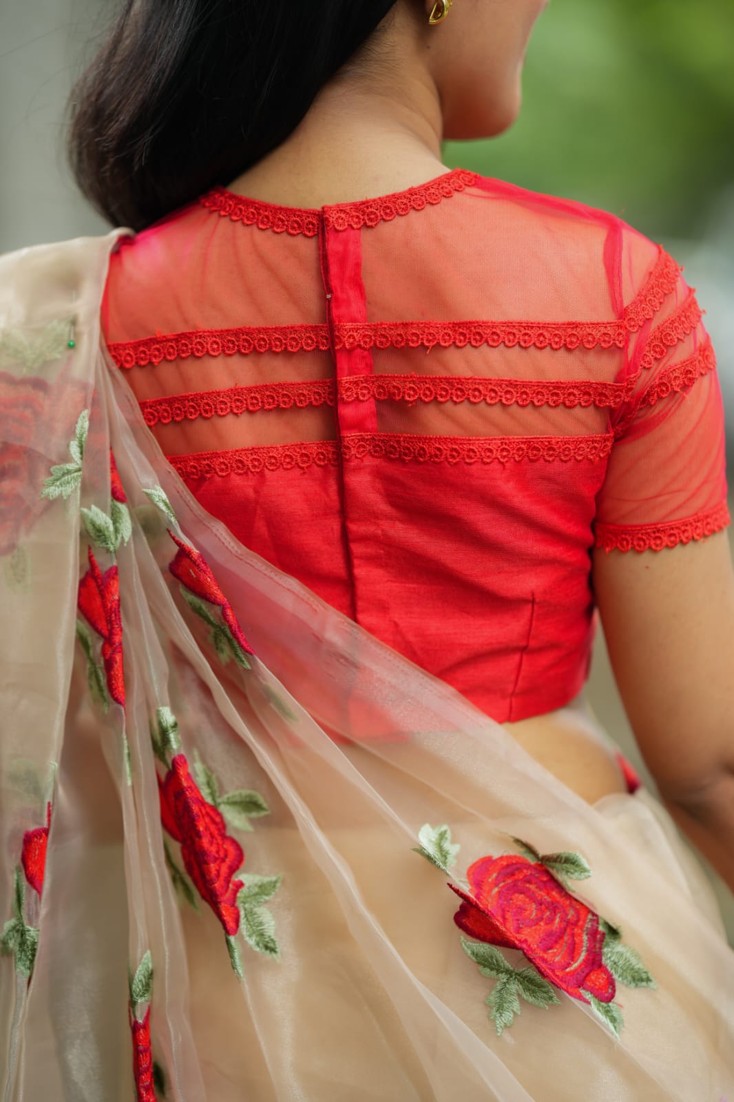 Glossy organza saree with red embroidery blouse