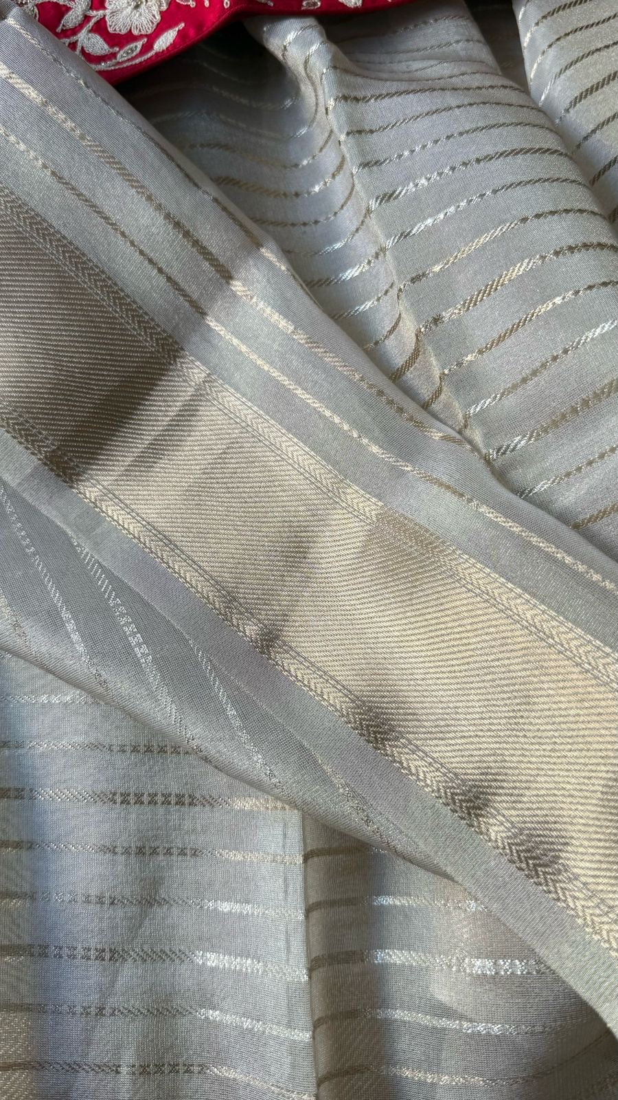 Cream tissue stripped saree with red silk hand work blouse
