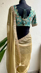 Golden soft tissue saree with blue floral embroidery blouse