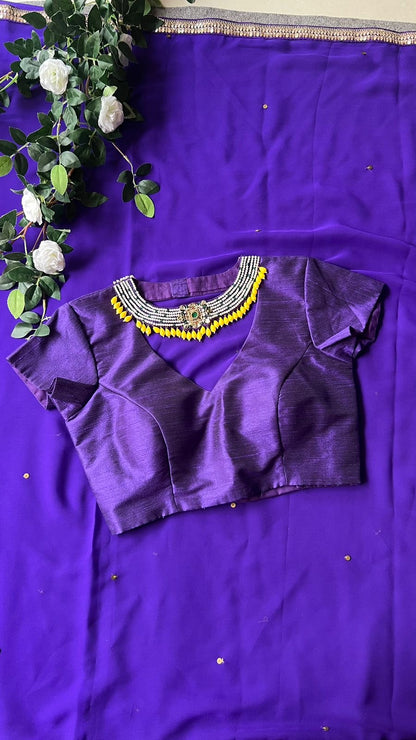 Purple georgette saree with purple jewel neck hand work blouse