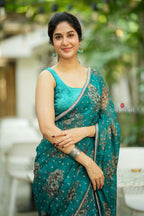 Peacock blue organza saree with velvet blouse