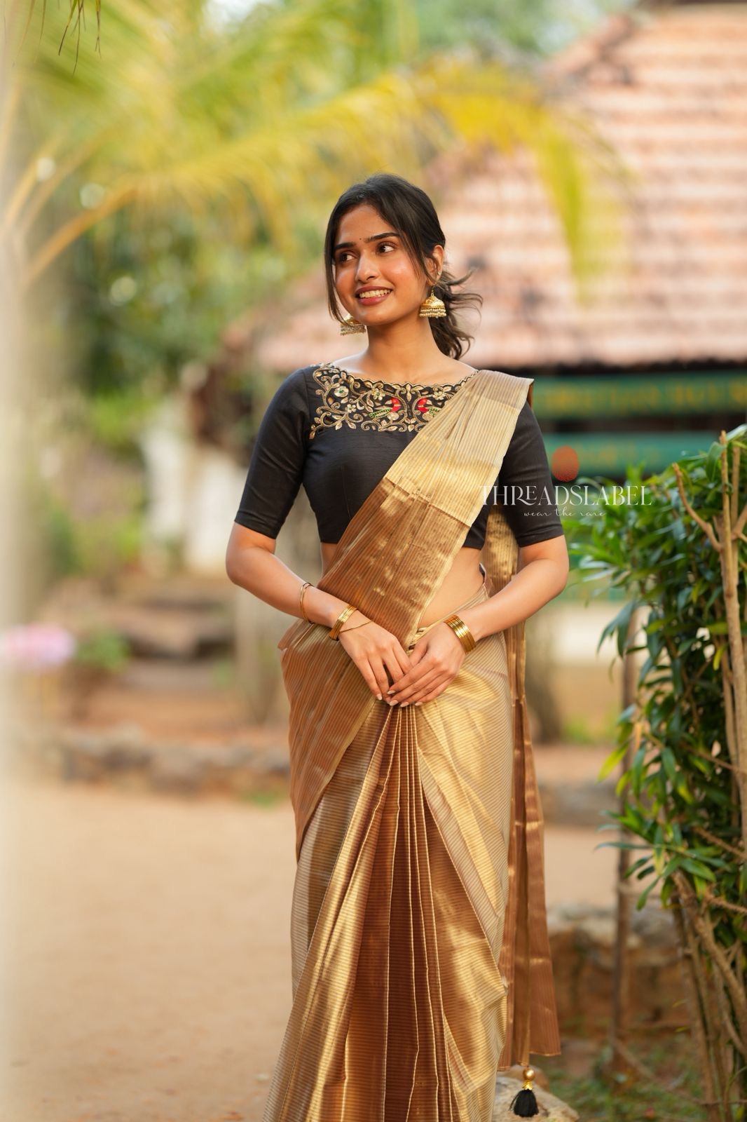Golden tissue saree with black hand work blouse