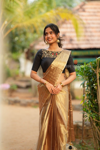 Golden tissue saree with black hand work blouse