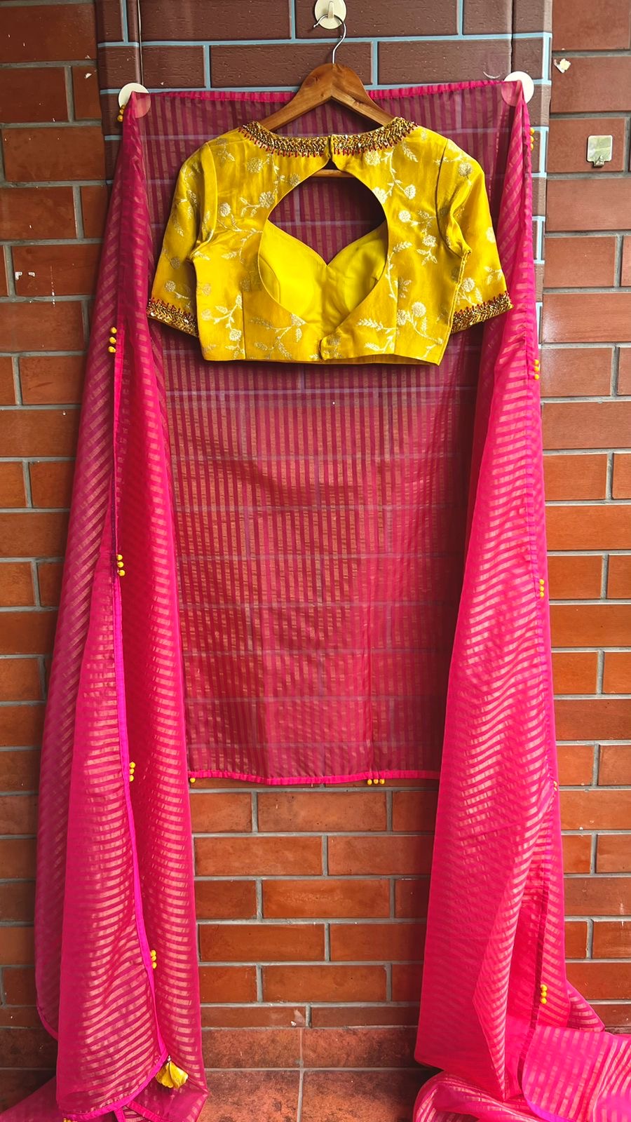 Pink stripped tissue saree with yellow floral hand work blouse