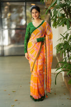 Orange viscose jute saree with green hakoba blouse