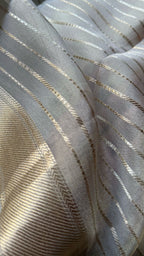 Cream tissue stripped saree with red silk hand work blouse