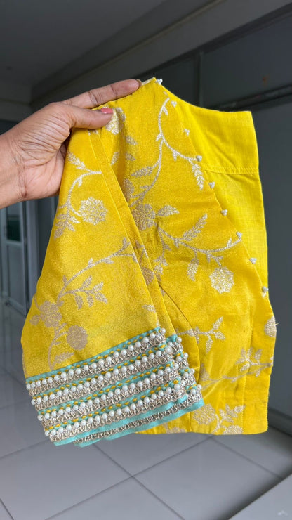 Blue glass tissue saree with yellow banarasi blouse