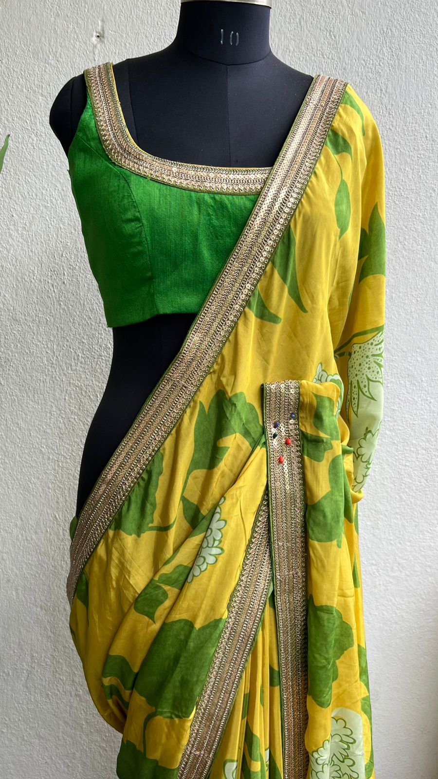 Yellow viscose saree with green silk embroidered blouse