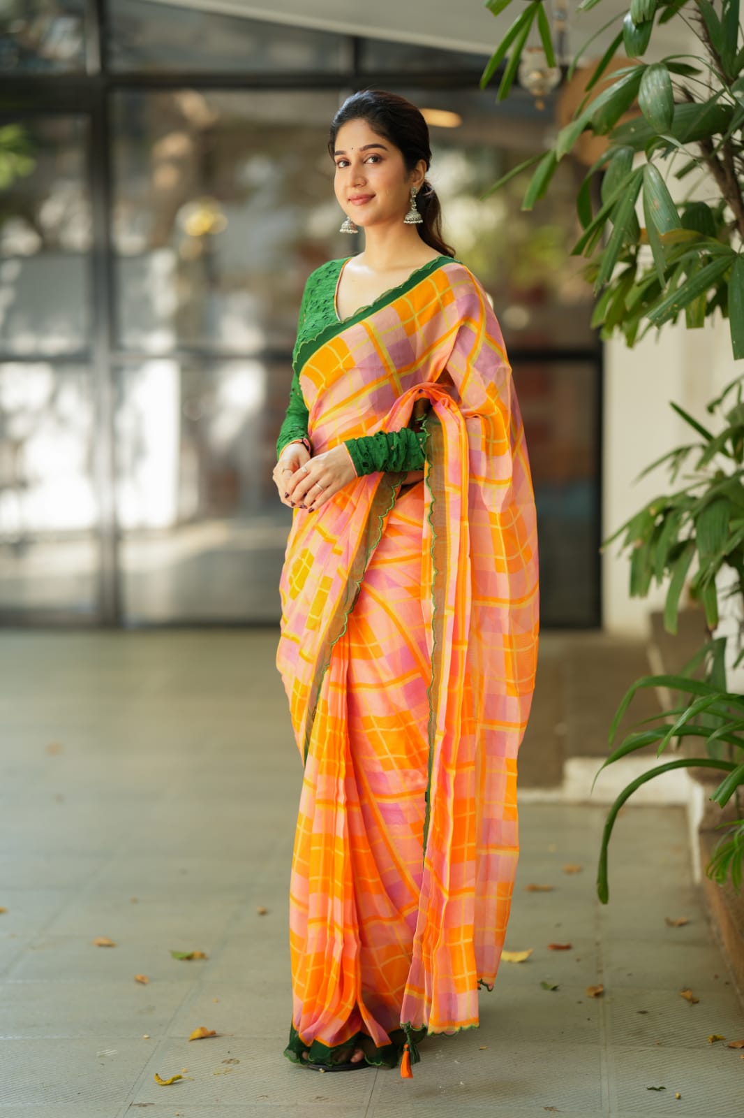 Orange viscose jute saree with green hakoba blouse
