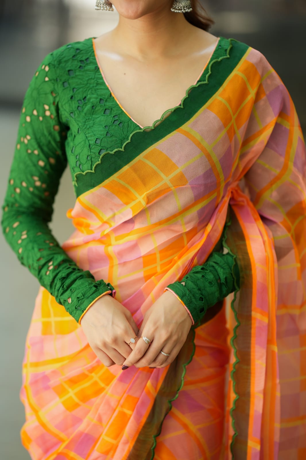 Orange viscose jute saree with green hakoba blouse