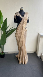 Golden cream tissue saree with black hand work blouse