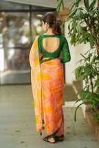 Orange viscose jute saree with green hakoba blouse