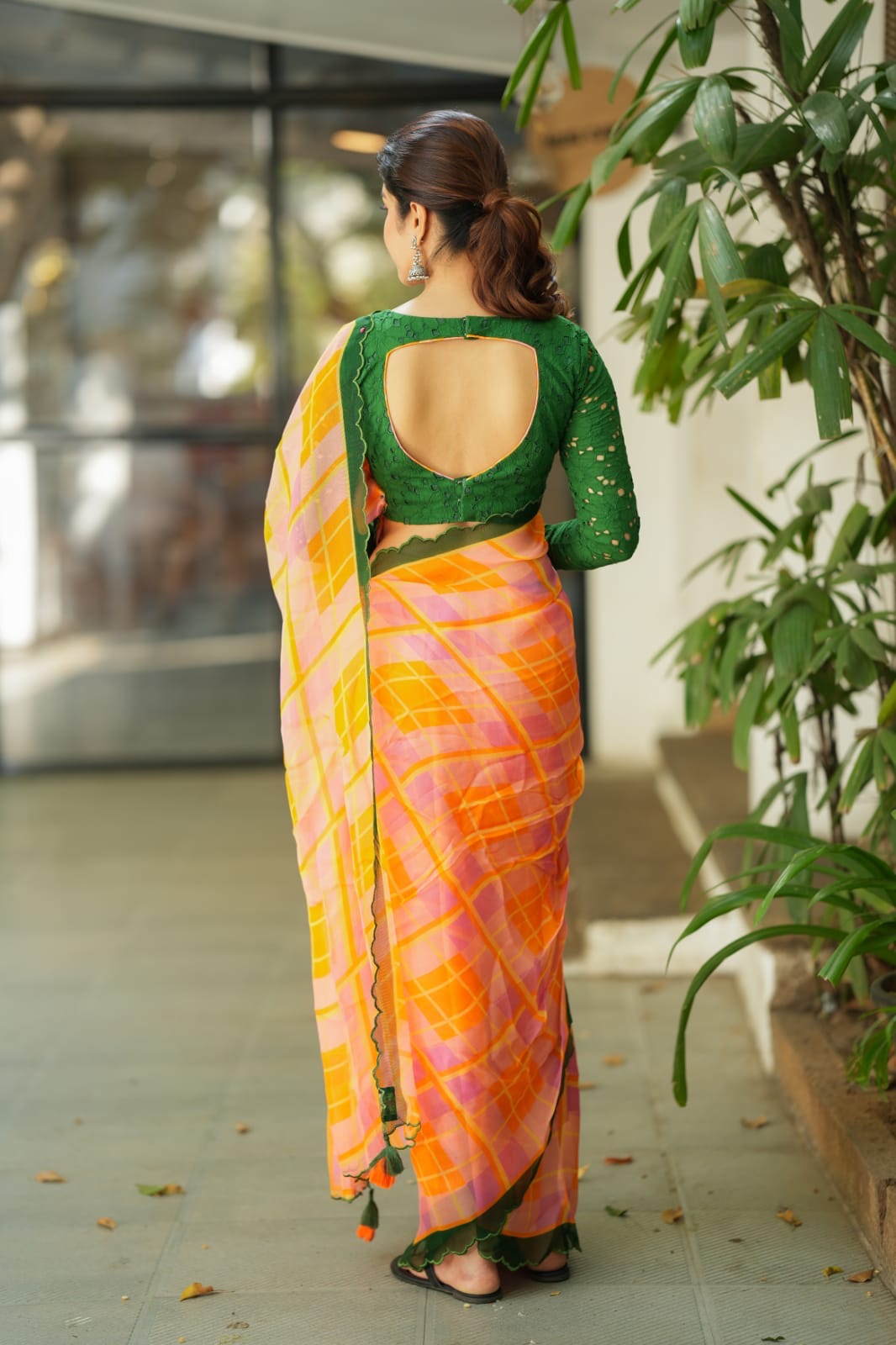 Orange viscose jute saree with green hakoba blouse