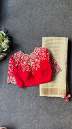 Cream tissue stripped saree with red silk hand work blouse