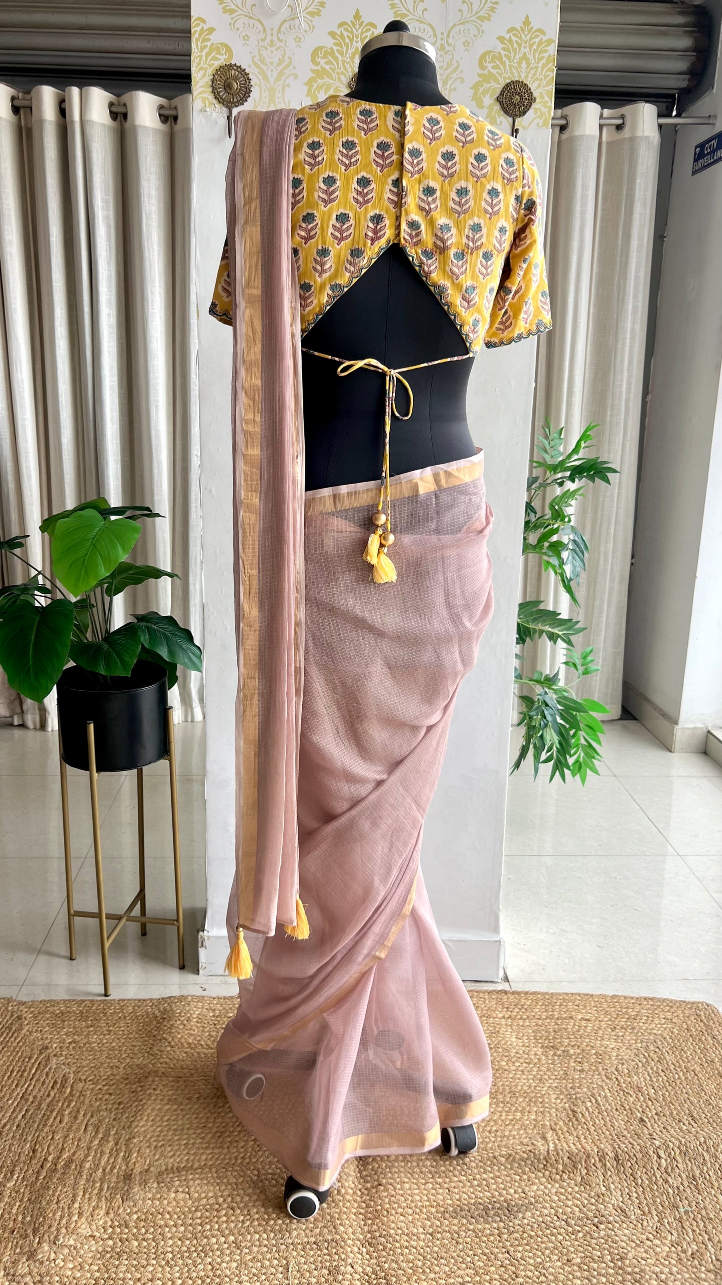 Light peach mul kota saree with yellow hand work blouse