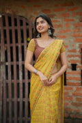Yellow chiffon floral saree with hand work blouse