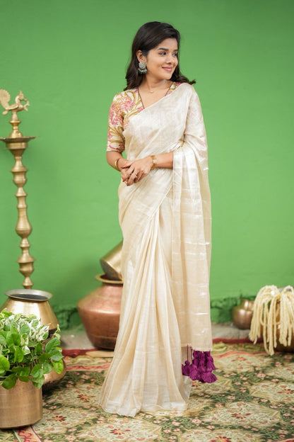 Cream soft tissue saree with embroidered blouse