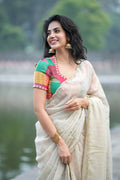 Beige georgette tissue saree with multi hand work blouse