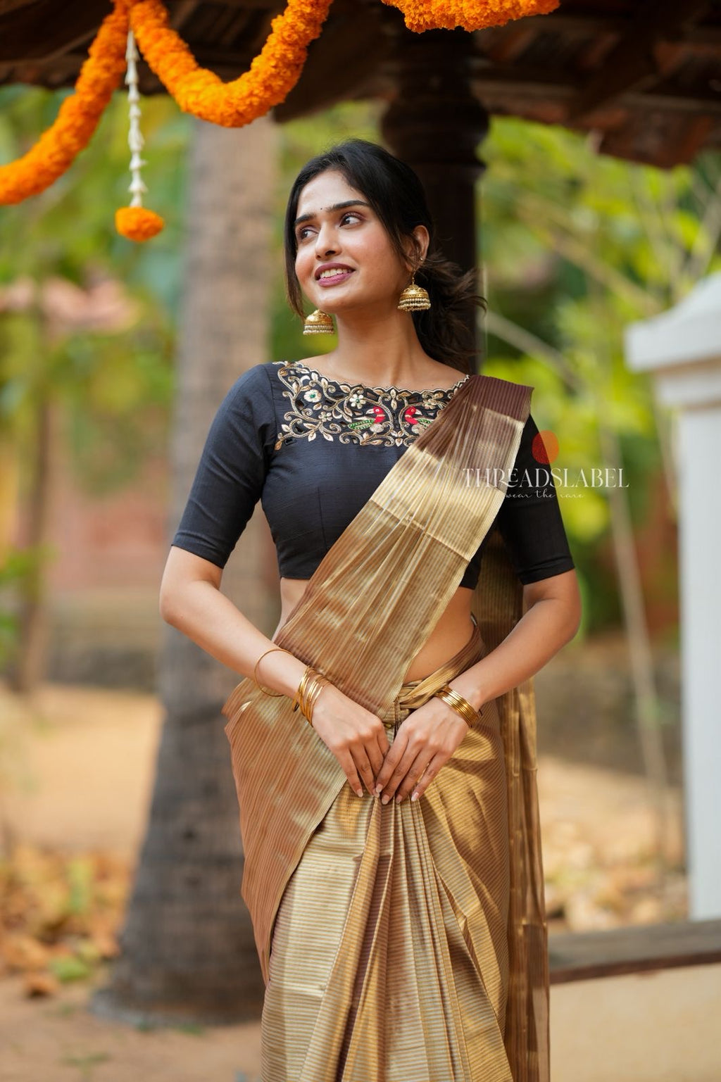 Golden tissue saree with black hand work blouse