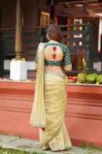 Gold tissue saree with green hand work blouse