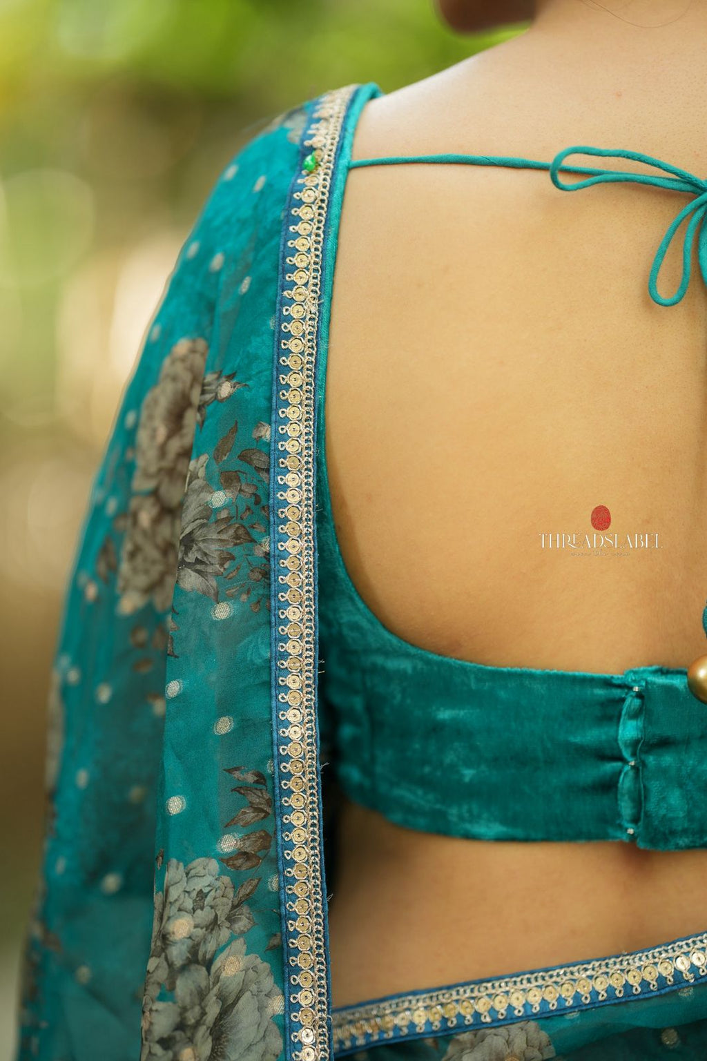 Peacock blue organza saree with velvet blouse