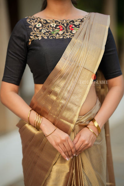 Golden tissue saree with black hand work blouse