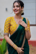 Green organza saree with yellow hand work blouse