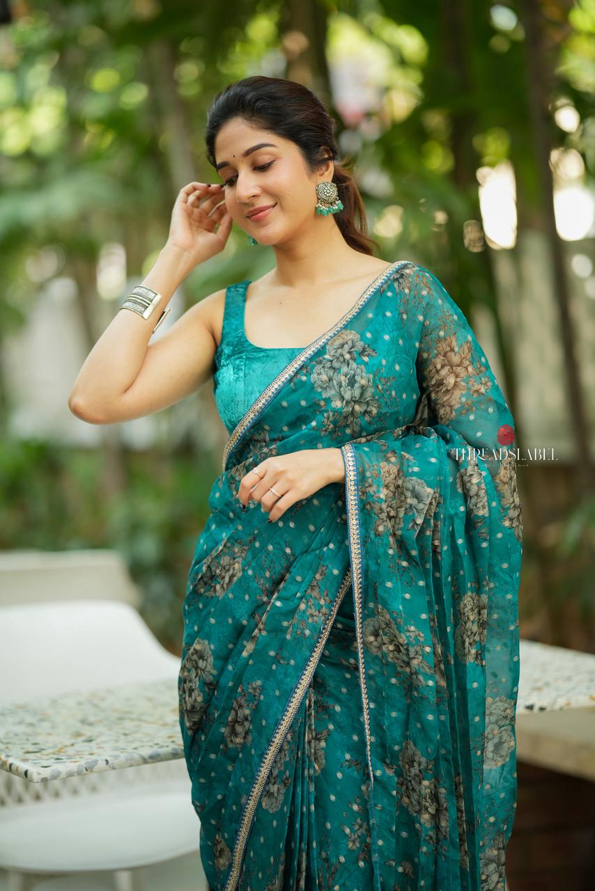 Peacock blue organza saree with velvet blouse
