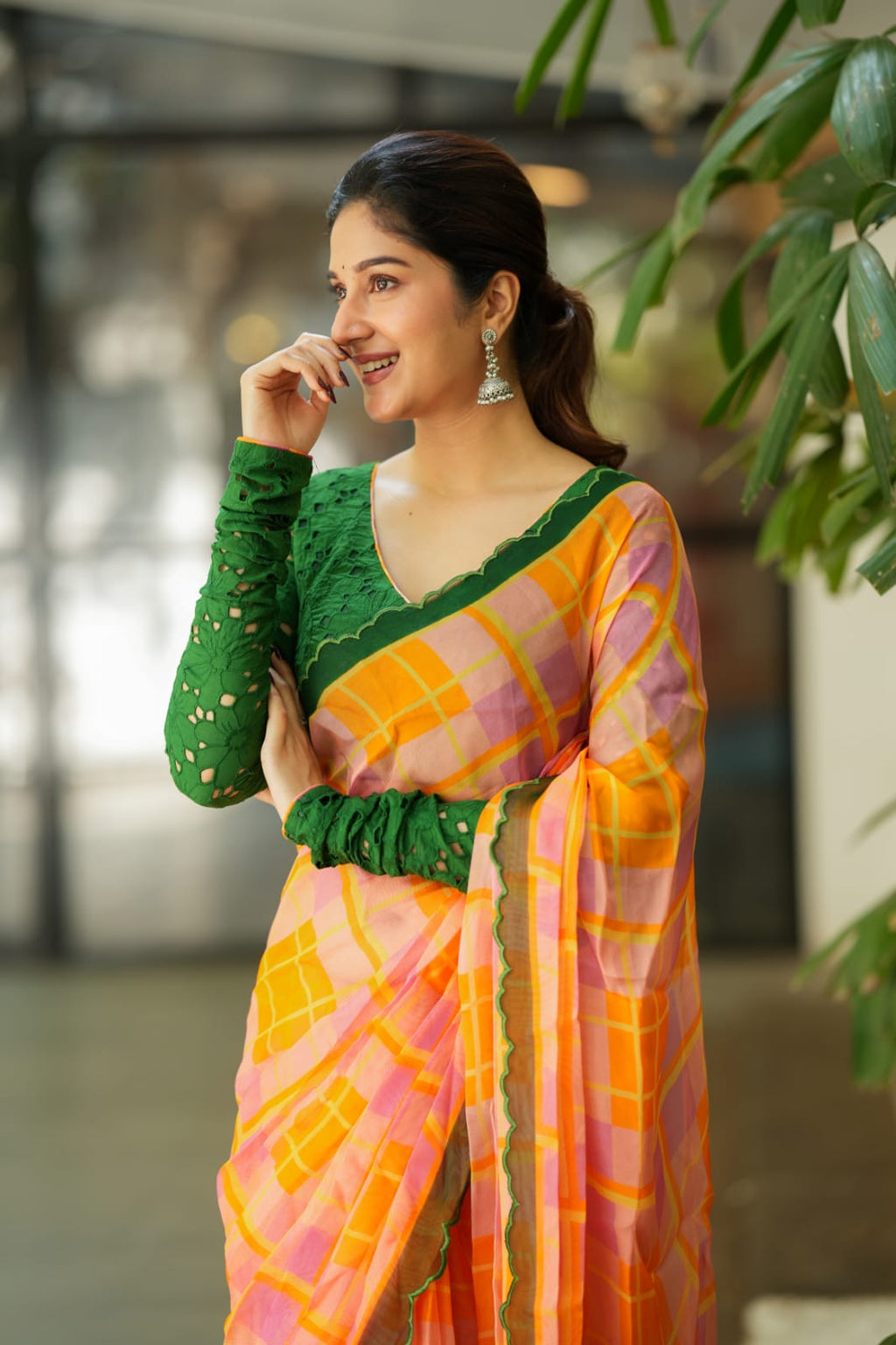 Orange viscose jute saree with green hakoba blouse