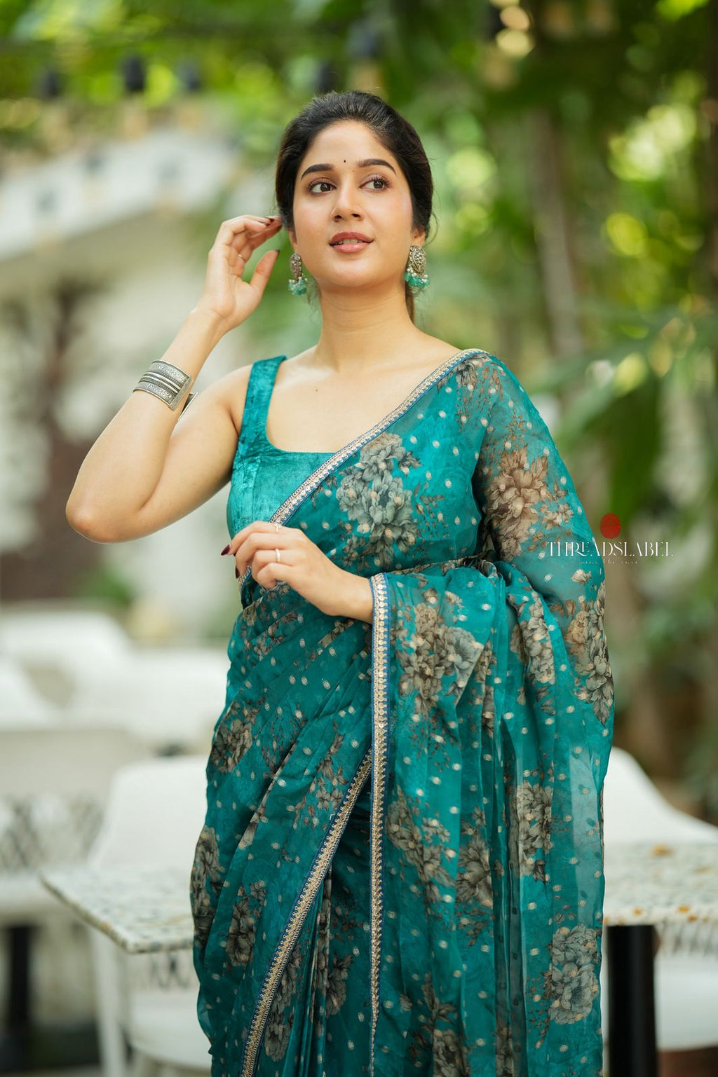 Peacock blue organza saree with velvet blouse