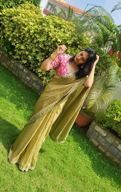 Green soft tissue saree with pink floral embroidered blouse