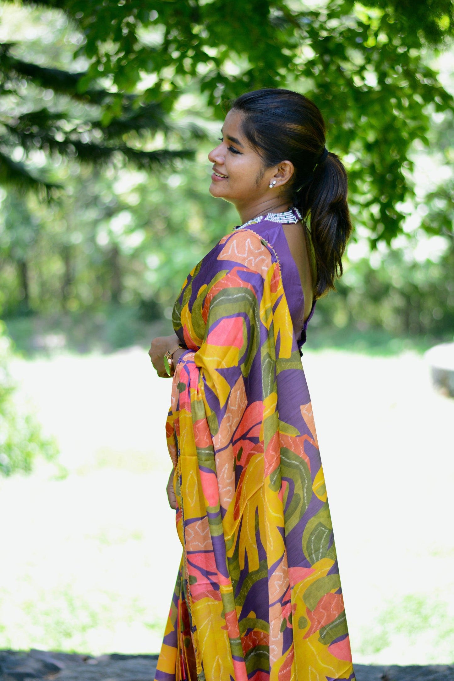 Yellow floral satin saree with purple jewel neck hand work blouse