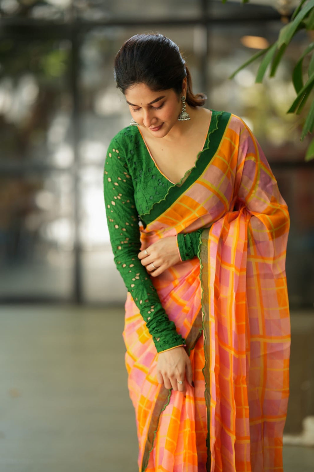 Orange viscose jute saree with green hakoba blouse