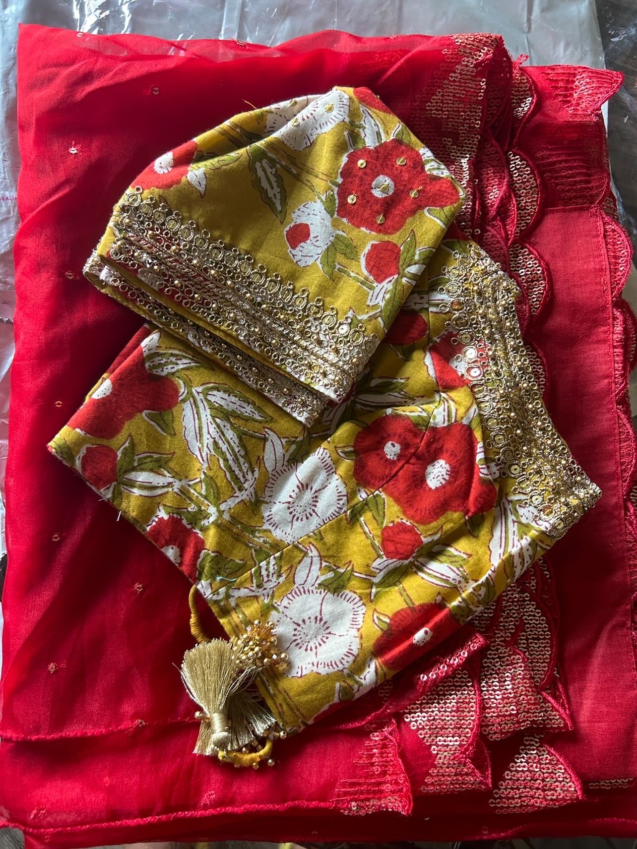 Red organza saree with cotton hand worked blouse