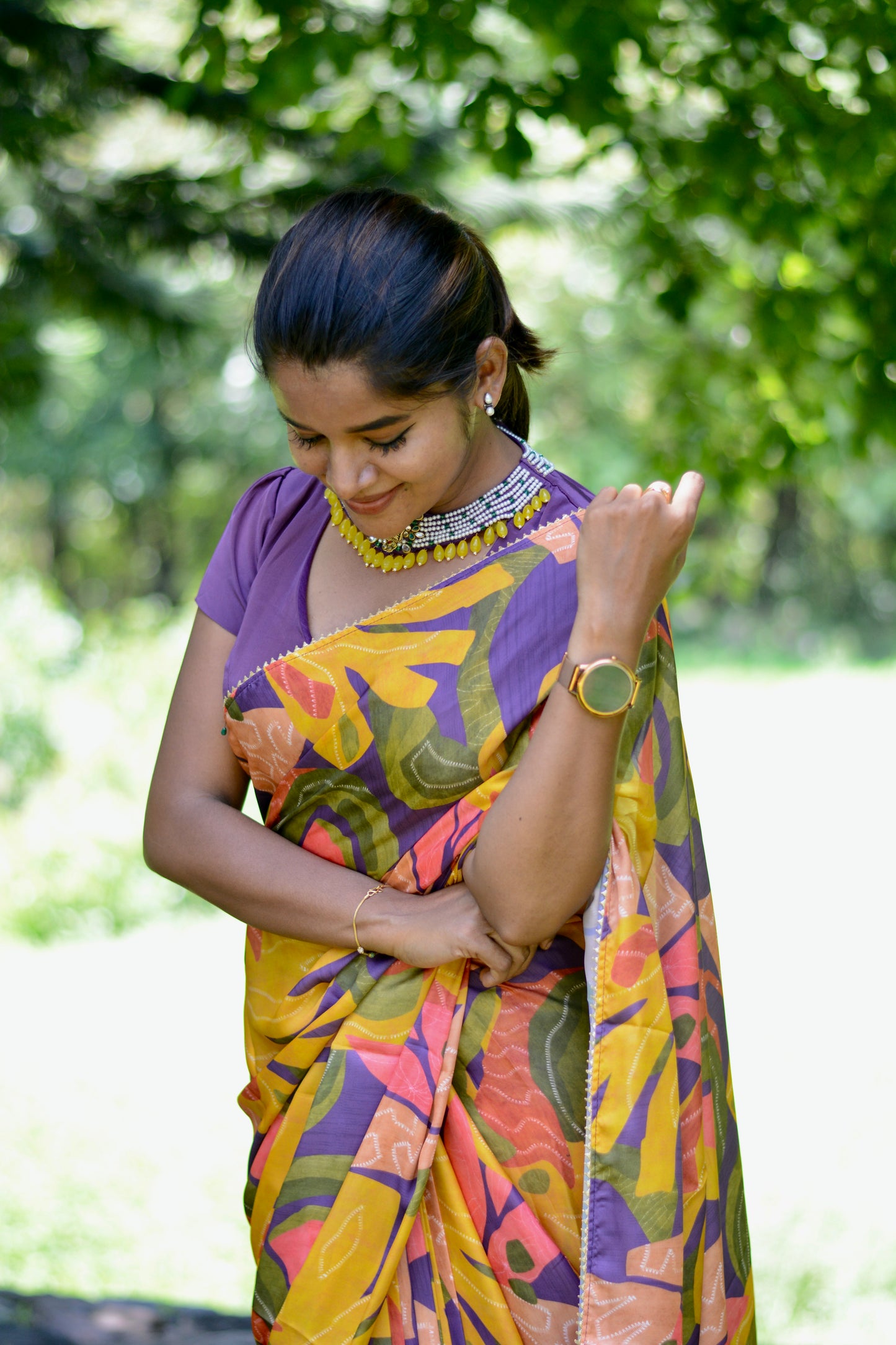 Yellow floral satin saree with purple jewel neck hand work blouse