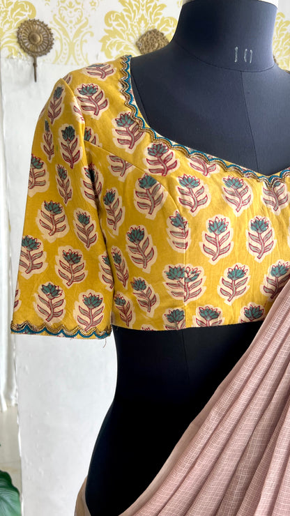 Light peach mul kota saree with yellow hand work blouse