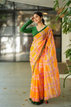 Orange viscose jute saree with green hakoba blouse