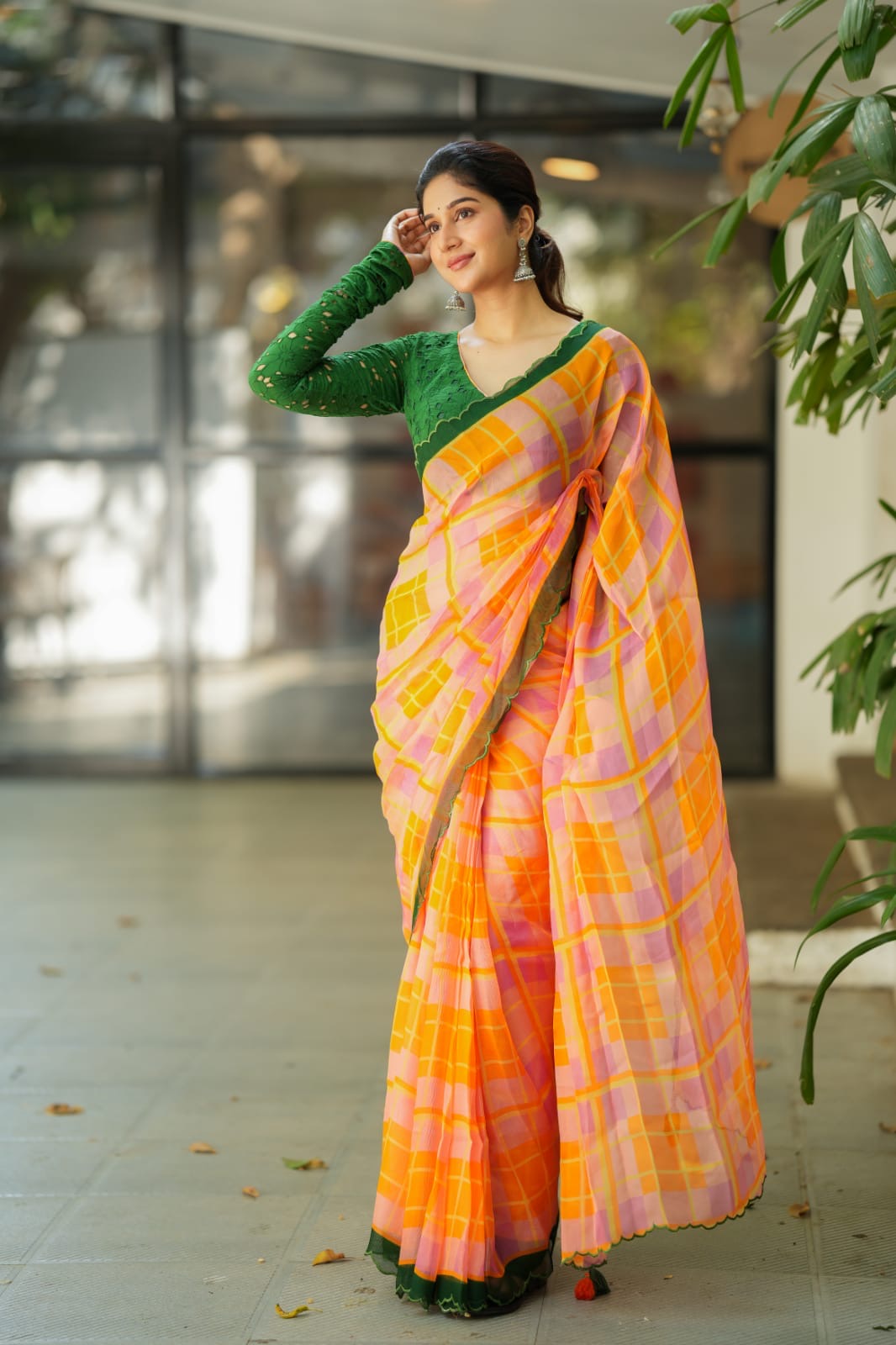 Orange viscose jute saree with green hakoba blouse